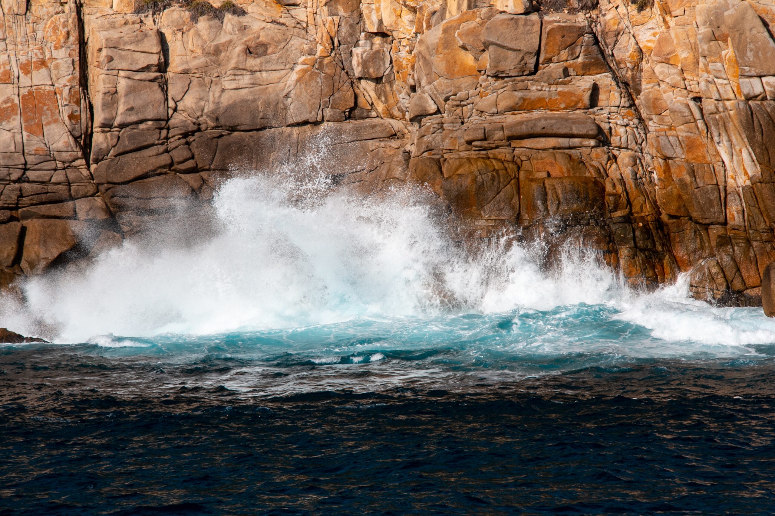 A beautiful shot of strong sea waves hitting on the cliff